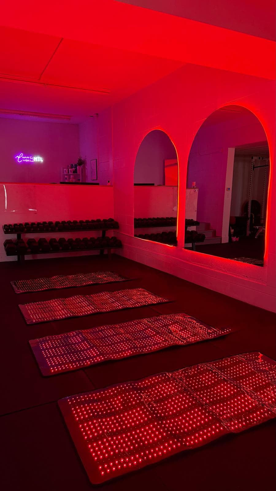 Red light therapy mats laid out in the Curve World studio
