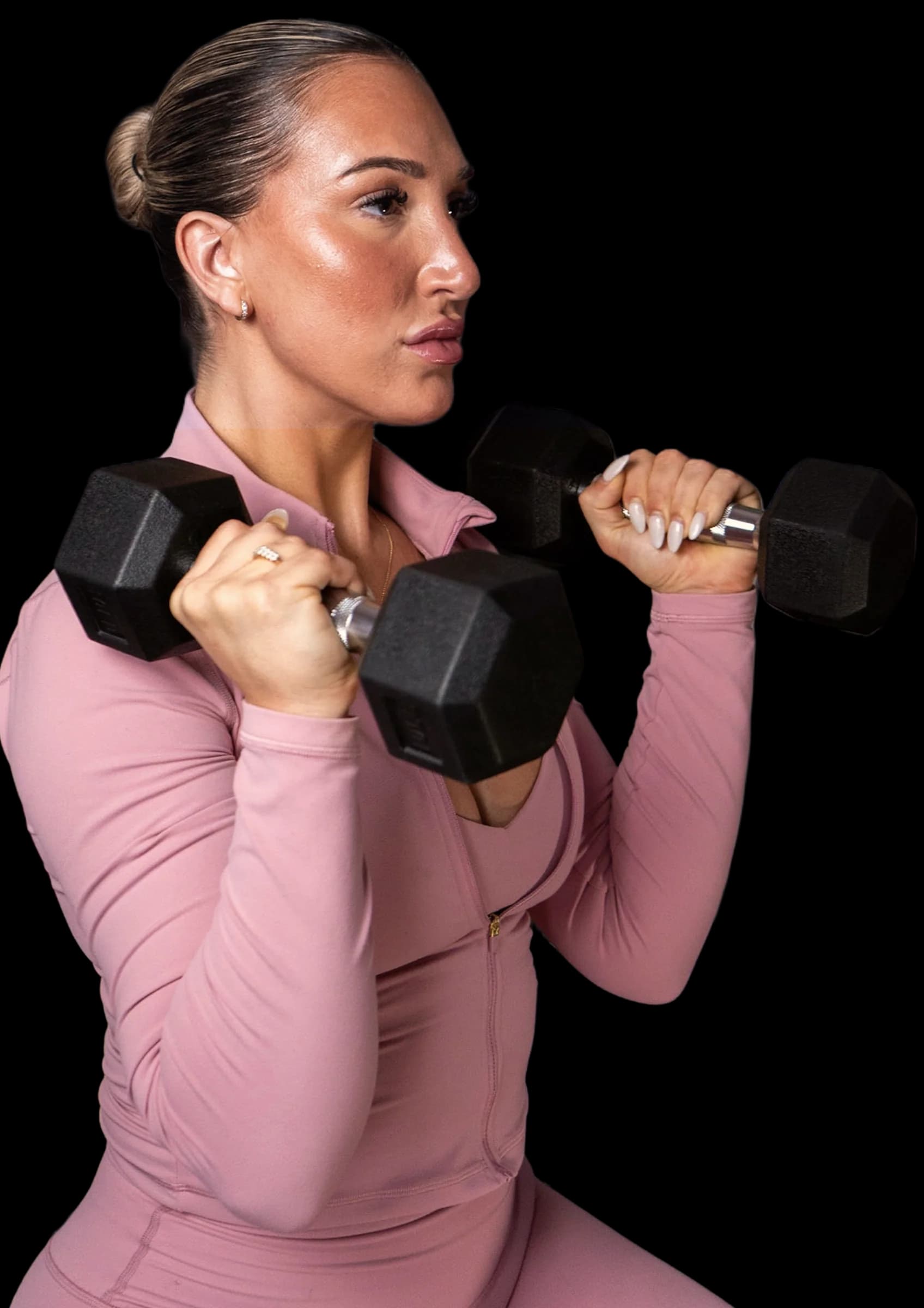 Woman in pink workout clothes lifting dumbbells